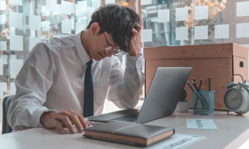 <br />
Wizard’s Webworks transforms outdated website challenges into growth opportunities, as symbolized by a frustrated businessman sitting at his desk.